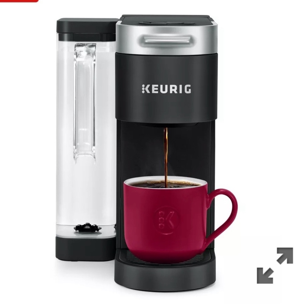 Keurig Single-Serve Coffee Maker in Black with Silver Accents and Red Mug